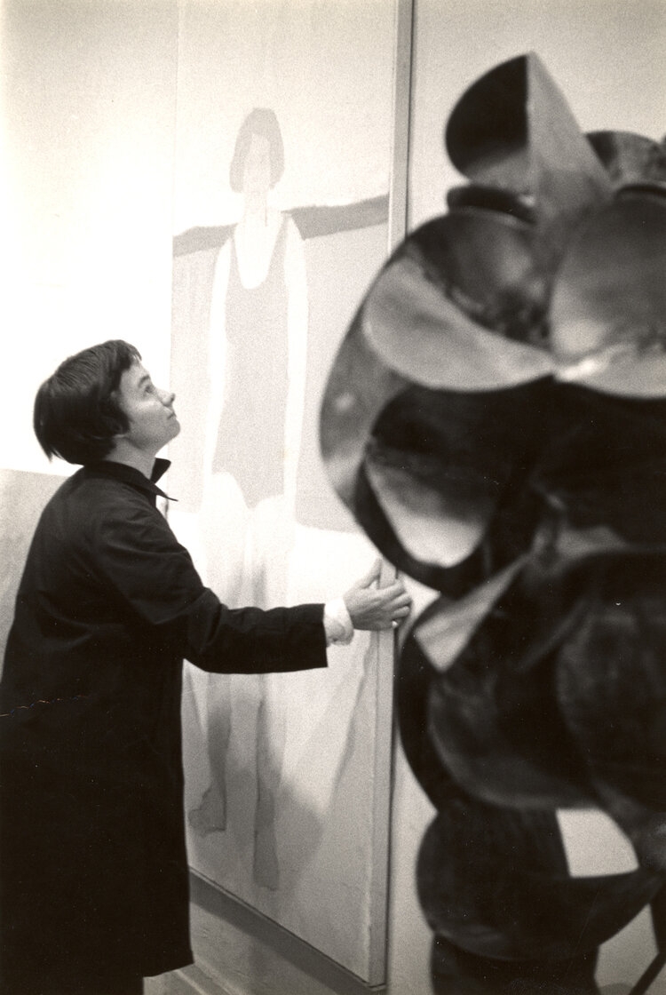Sally Hazelet Drummond hanging an Alex Katz painting at Tanager Gallery.